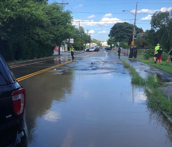 Photo of flooded street as a result of a broken water main.